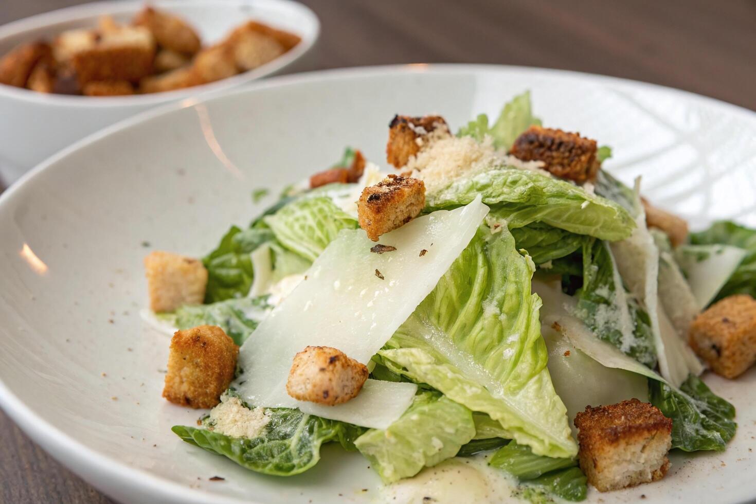 Close-up of a Caesar Salad with Croutons and Parmesan Cheese photo