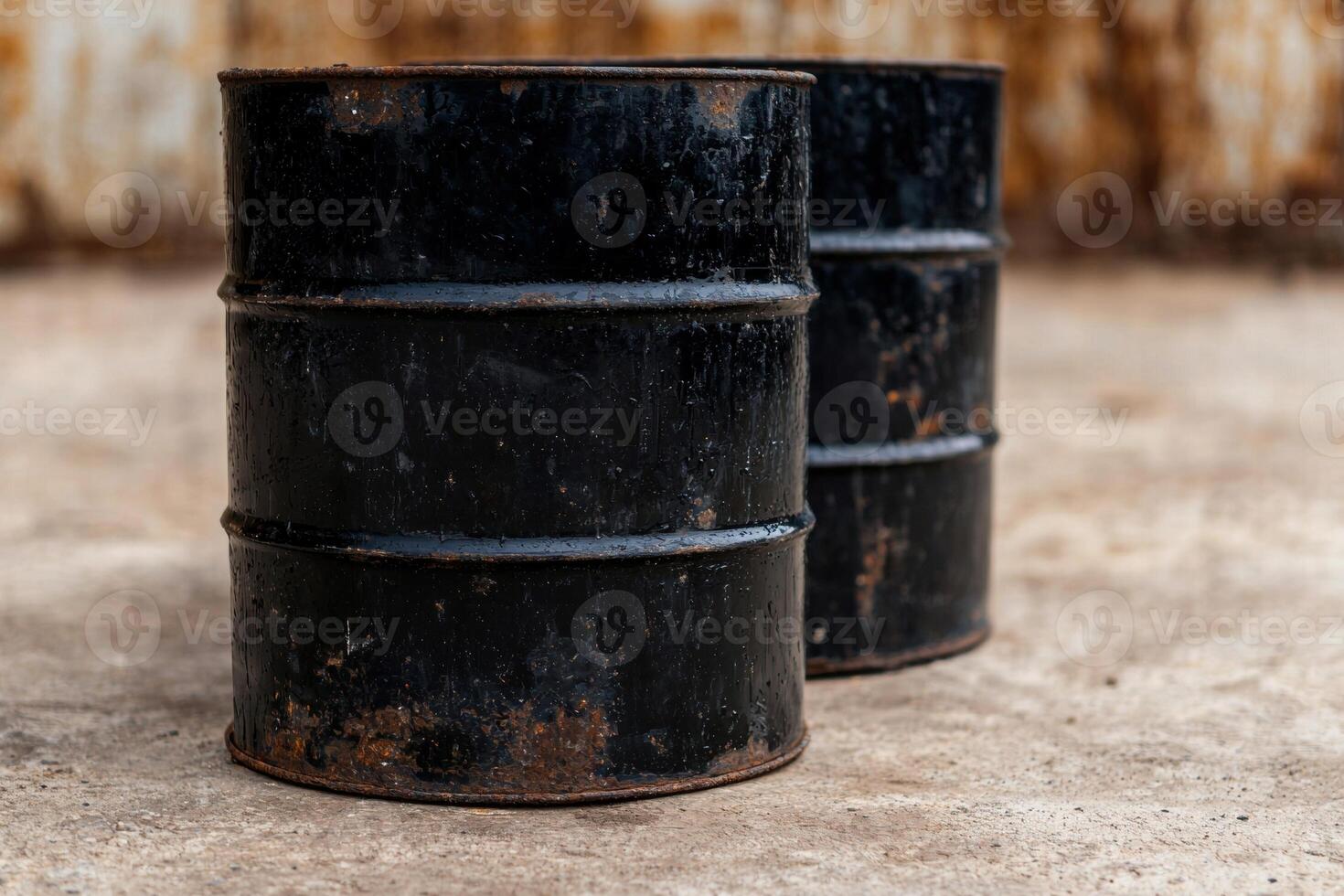 Rusty oil barrels stacked on a wooden surface photo