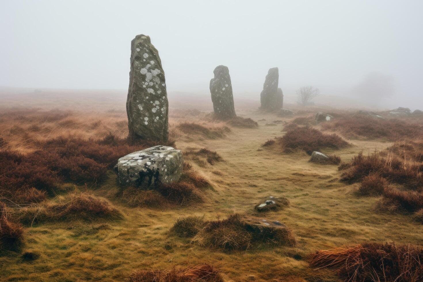 Mysterious stone monoliths in misty landscape photo
