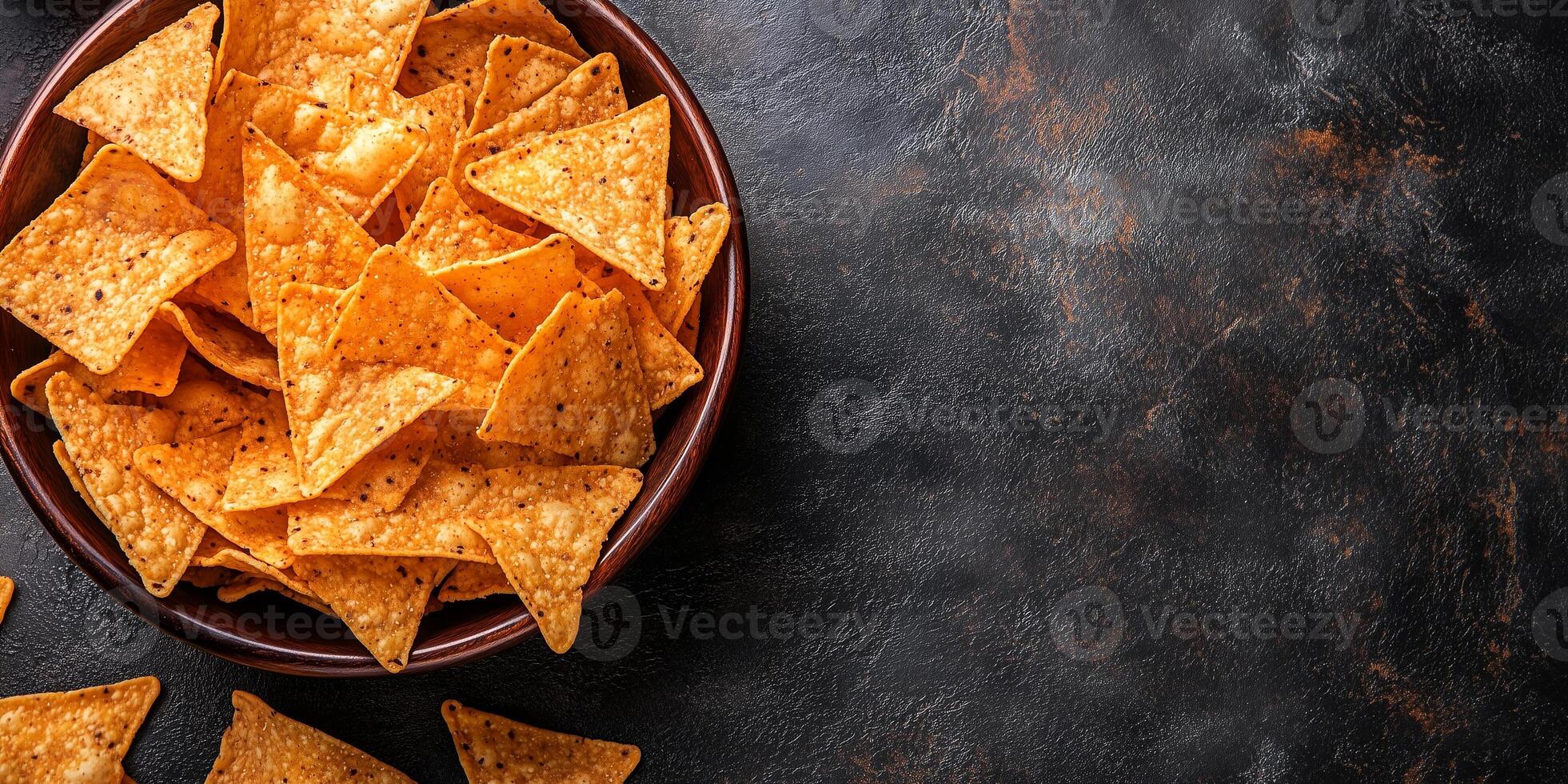 Close-up of tortilla chips in a deep bowl with visible surface details and no garnish, food setting photo