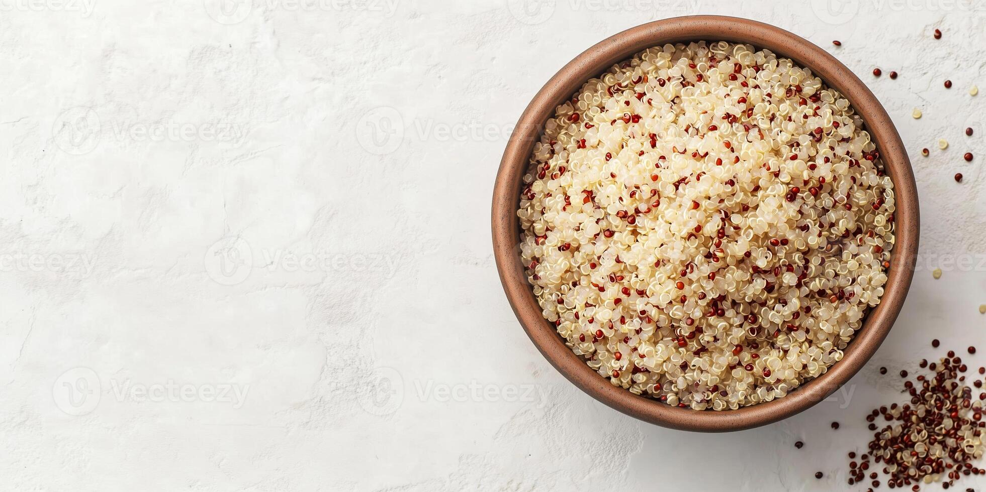 Close-up view of quinoa grains in a deep, round bowl with visible ingredients on top, meal photography photo