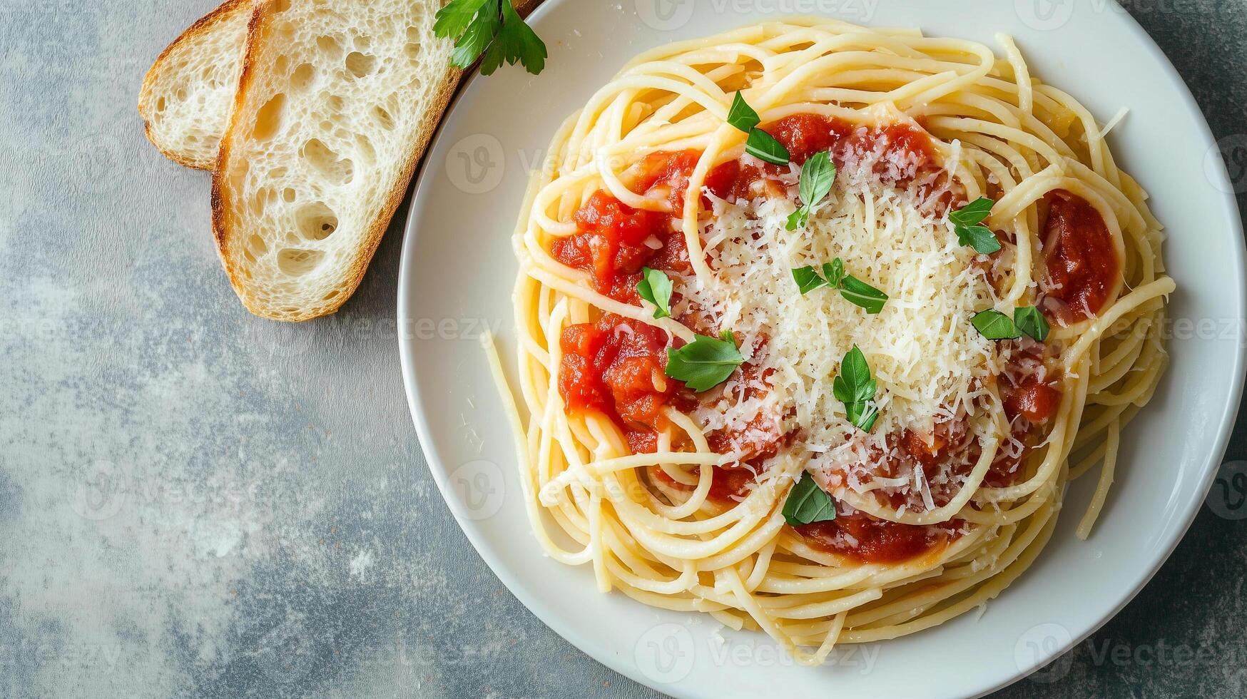 Plate of cooked spaghetti with tomato sauce and grated cheese, served with bread, food photography photo