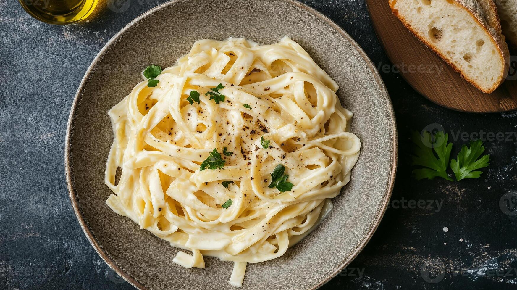 Fettuccine in Alfredo sauce with a slice of bread on a white plate, culinary photography photo