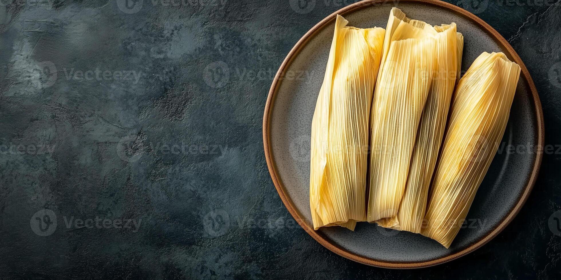 Portion of tamales with corn husks fully wrapped, arranged in a row on a simple, round dish, culinary photography photo