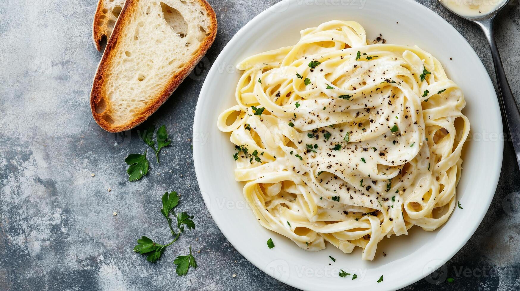 Fettuccine in Alfredo sauce with a slice of bread on a white plate, gastronomy photography photo