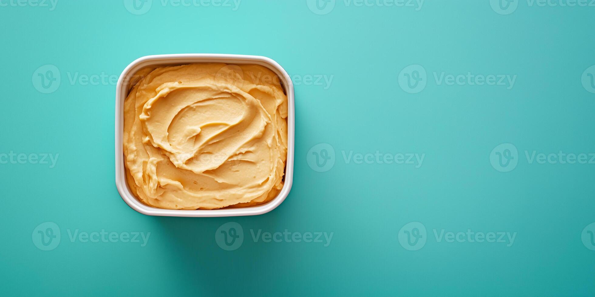 Dip in a square container with no additional elements or adornments, food setting photo