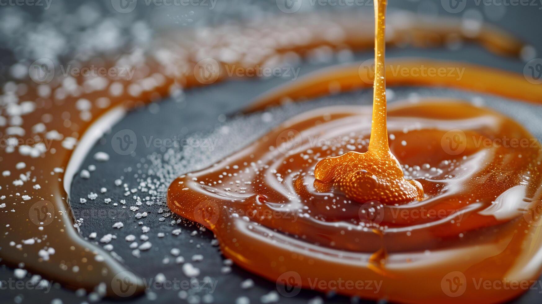 Close-up view of caramel sauce being drizzled onto a flat surface, food photography photo
