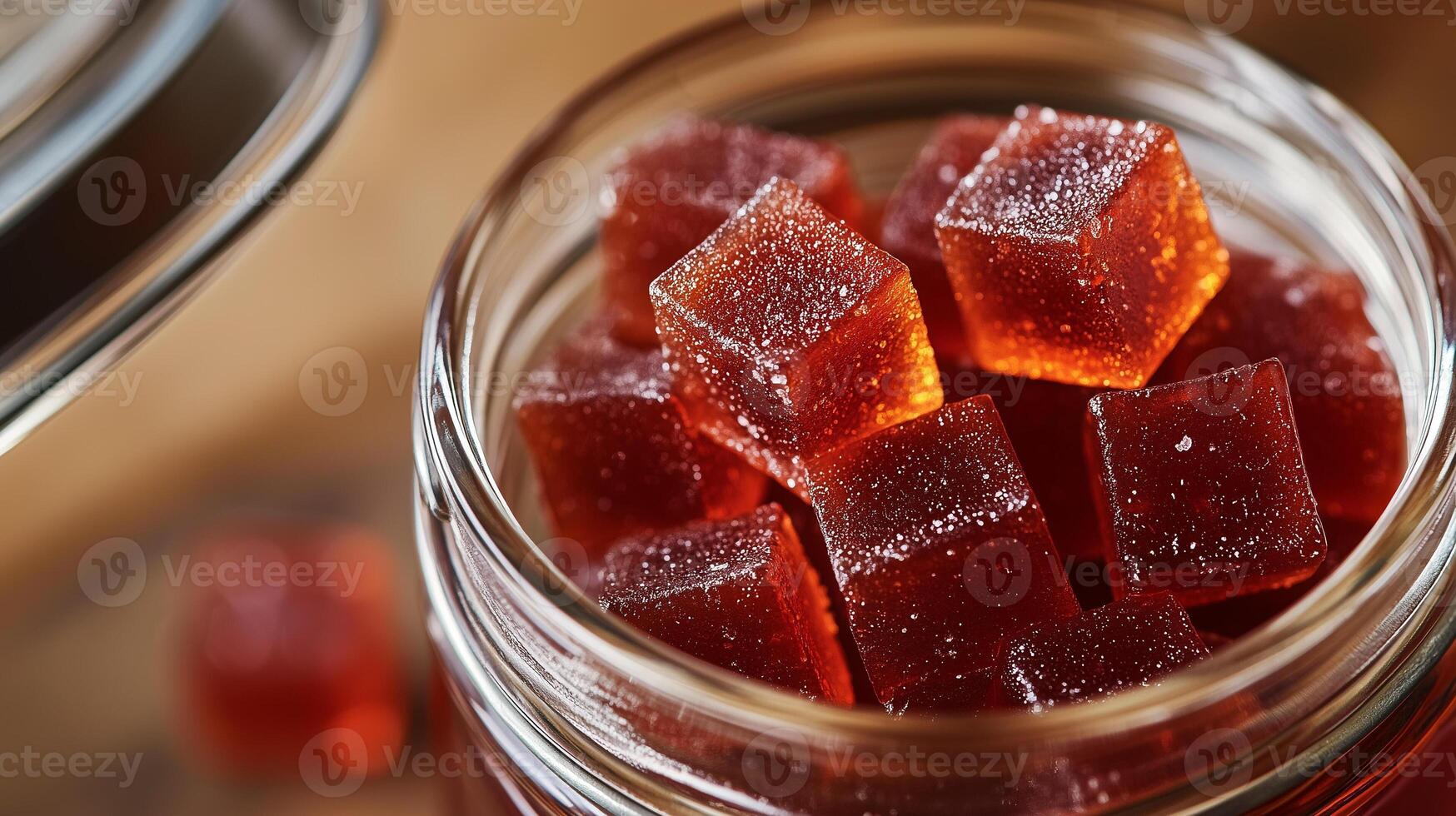 Close-up of chili gummy squares in a glass jar, lid partially open, gastronomy photography photo
