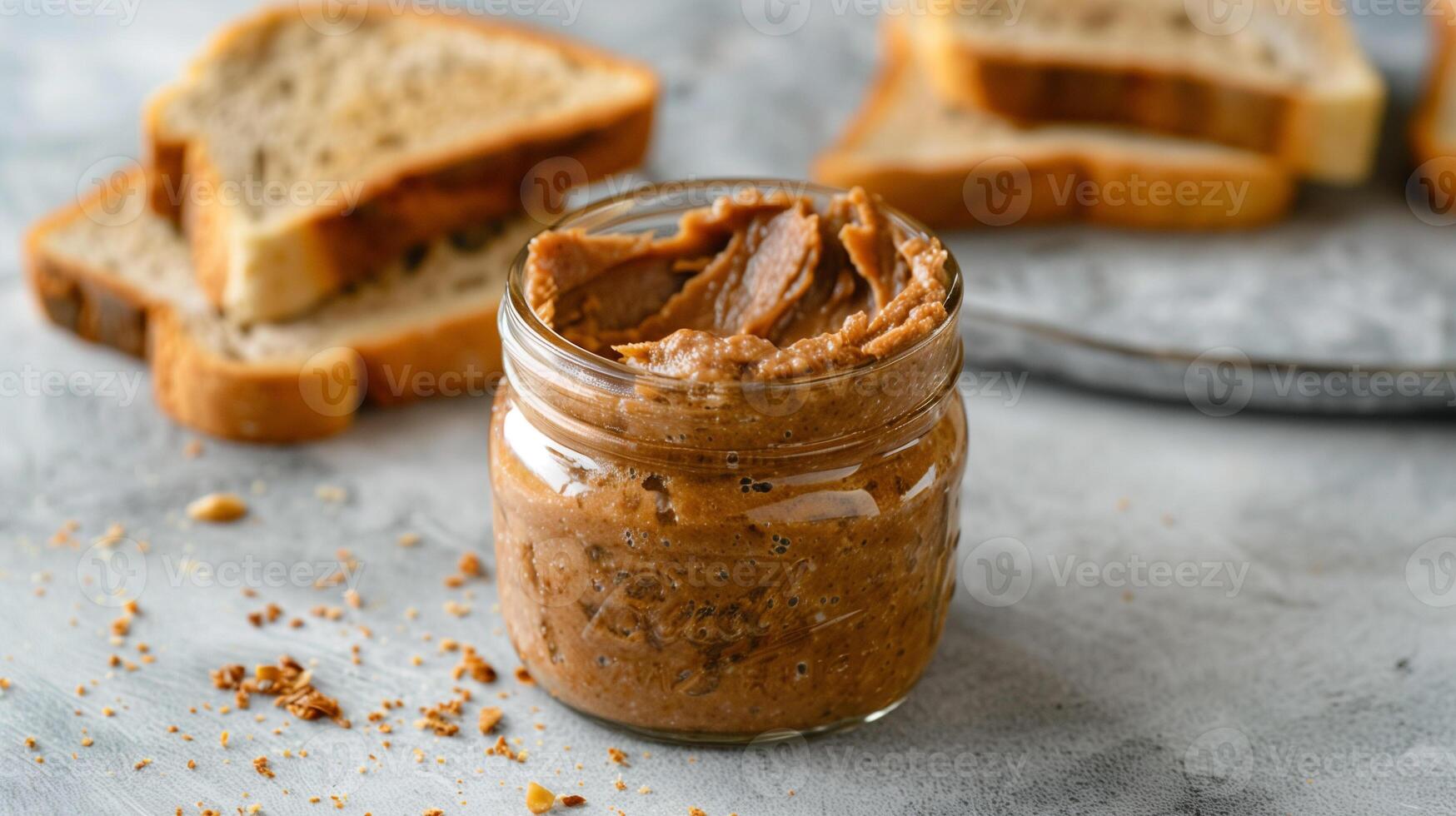 Jar of nut-free spread with the lid removed, beside a slice of toasted bread, gastronomy photography photo
