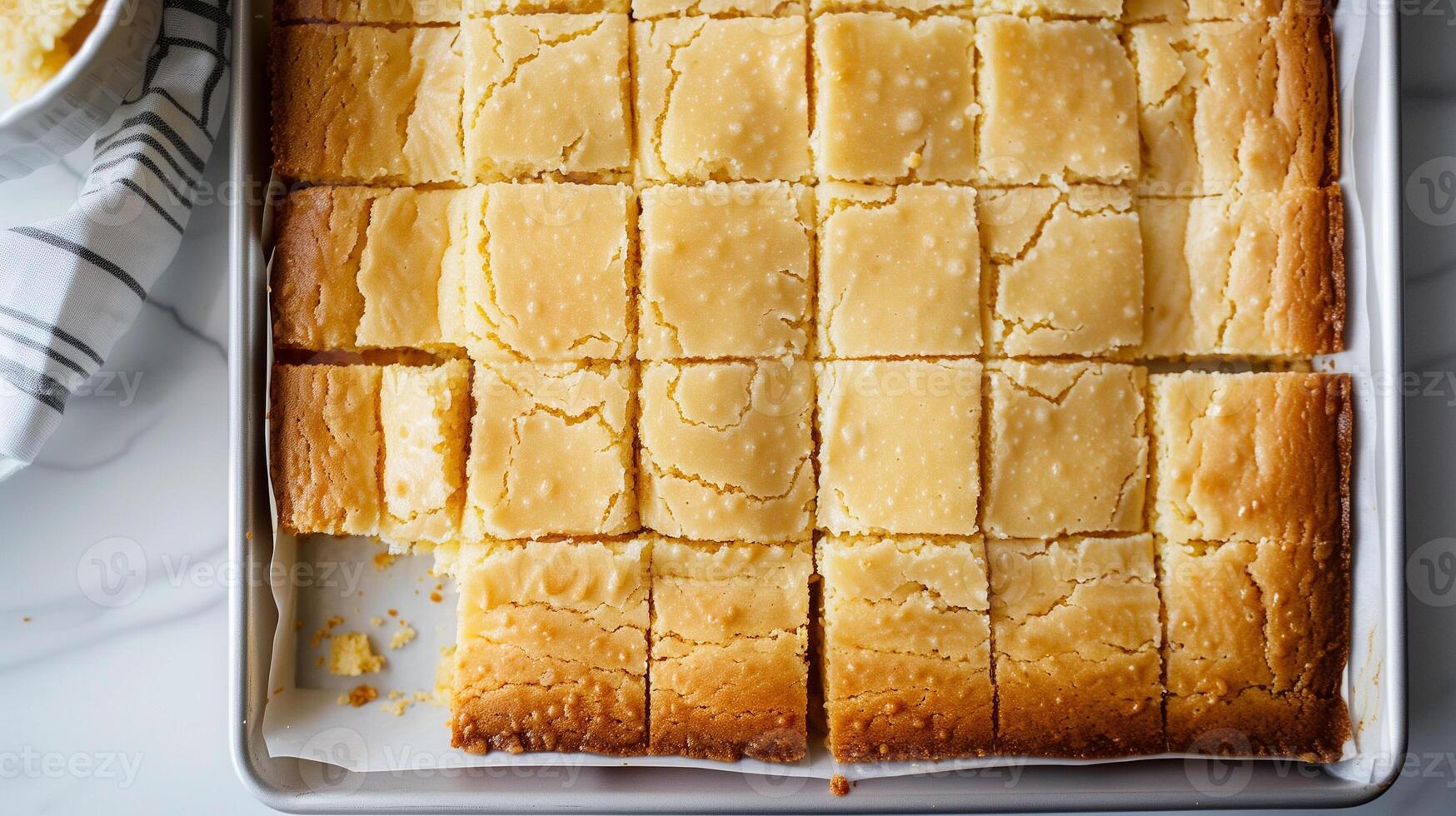 Sheet cake, partially cut into squares, on a plain rectangular tray, gastronomy photography photo
