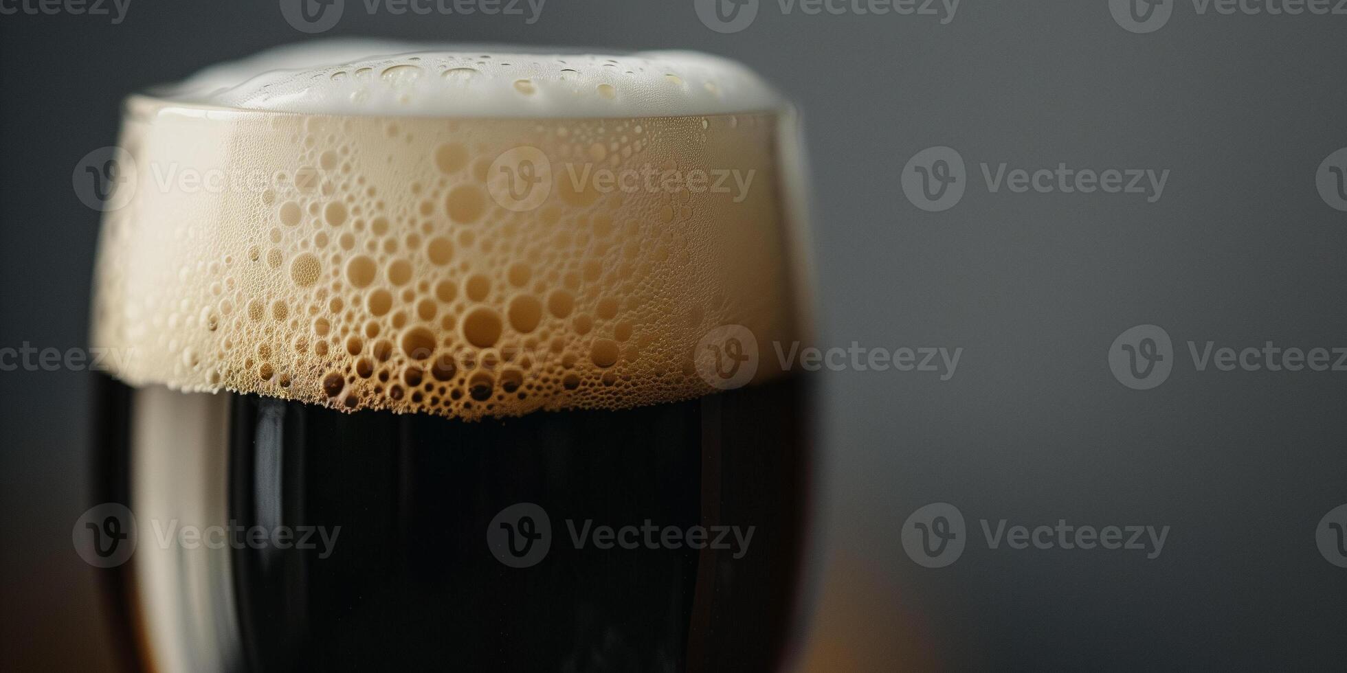 Close-up shot of a stout beer's creamy head in a clear pint glass, food setting photo