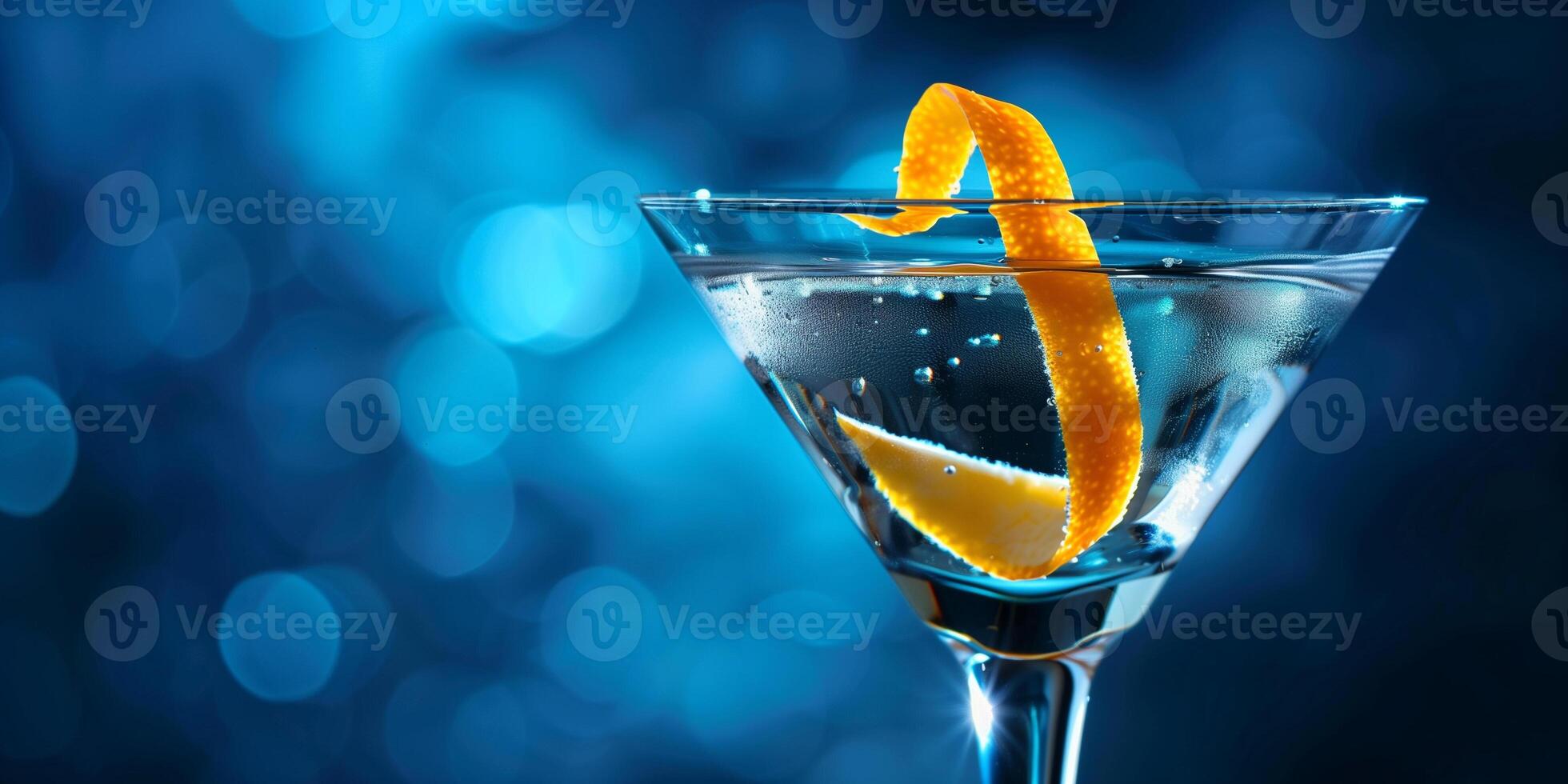Martini glass with clear drink and lemon peel garnish, meal photography photo