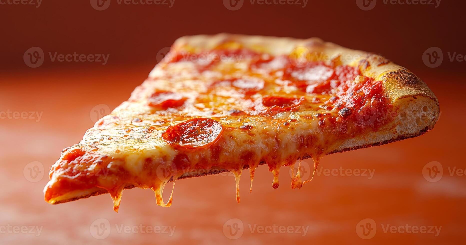 A slice of pepperoni pizza is being lifted off a table. The pizza is covered in cheese and pepperoni, and it is dripping with sauce. Concept of indulgence and enjoyment photo