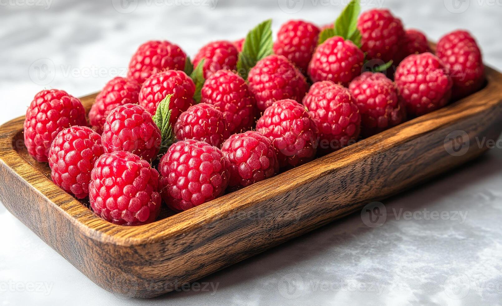 Raspberries artfully arranged in wood. Ripe raspberries are neatly arranged in a wooden tray, showcasing their vibrant color and inviting texture. photo