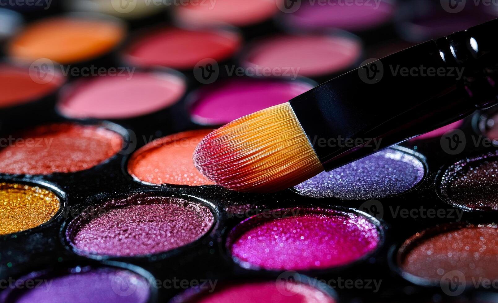 Colorful makeup palette with brush applying color. Close-up view of a makeup palette with vivid eyeshadow colors and a brush applying a shade to the surface. photo