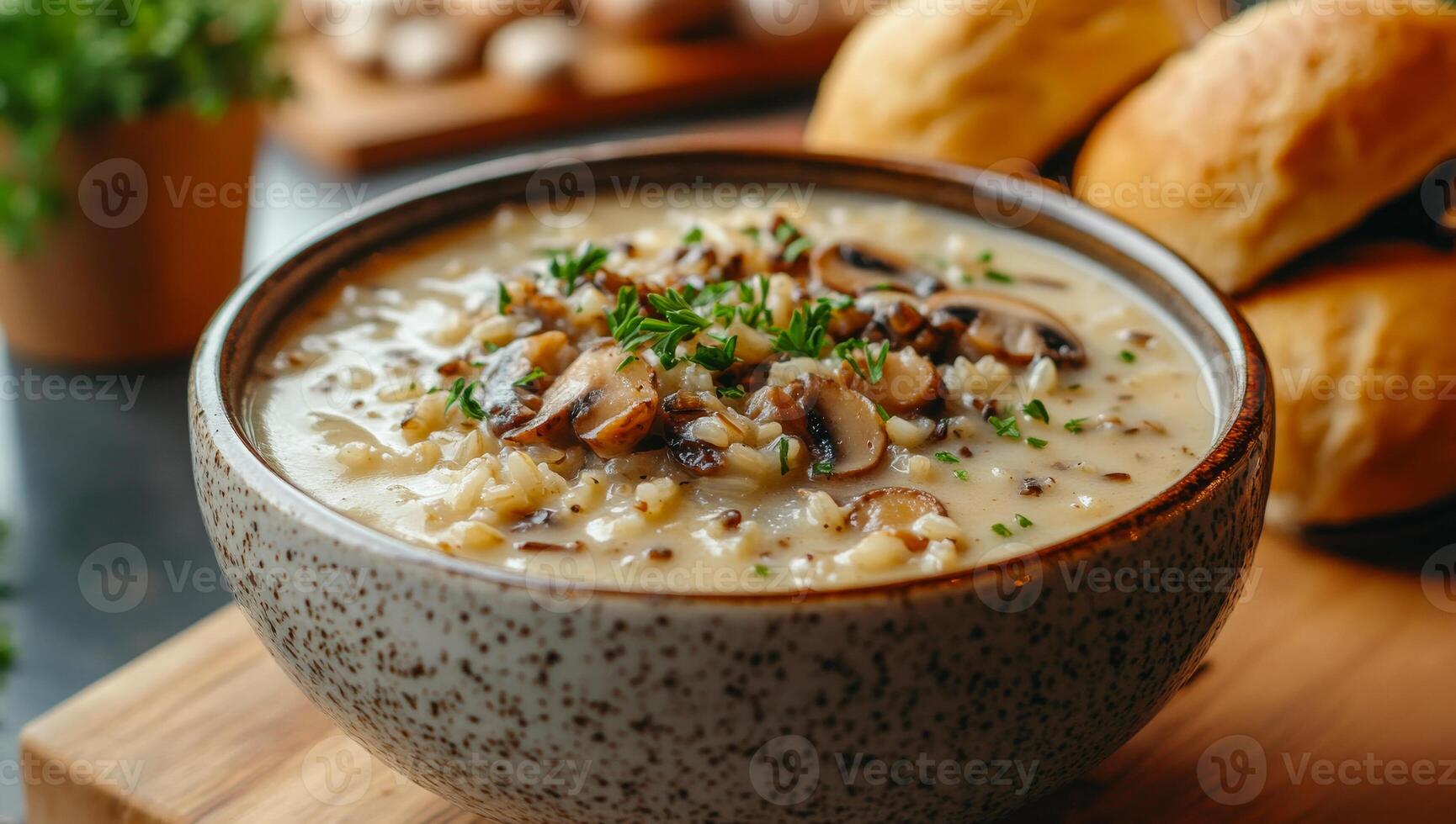 Delicious bowl of creamy mushroom soup with rolls. A hearty bowl of creamy mushroom soup topped with fresh herbs, accompanied by soft bread rolls on a wooden board. photo