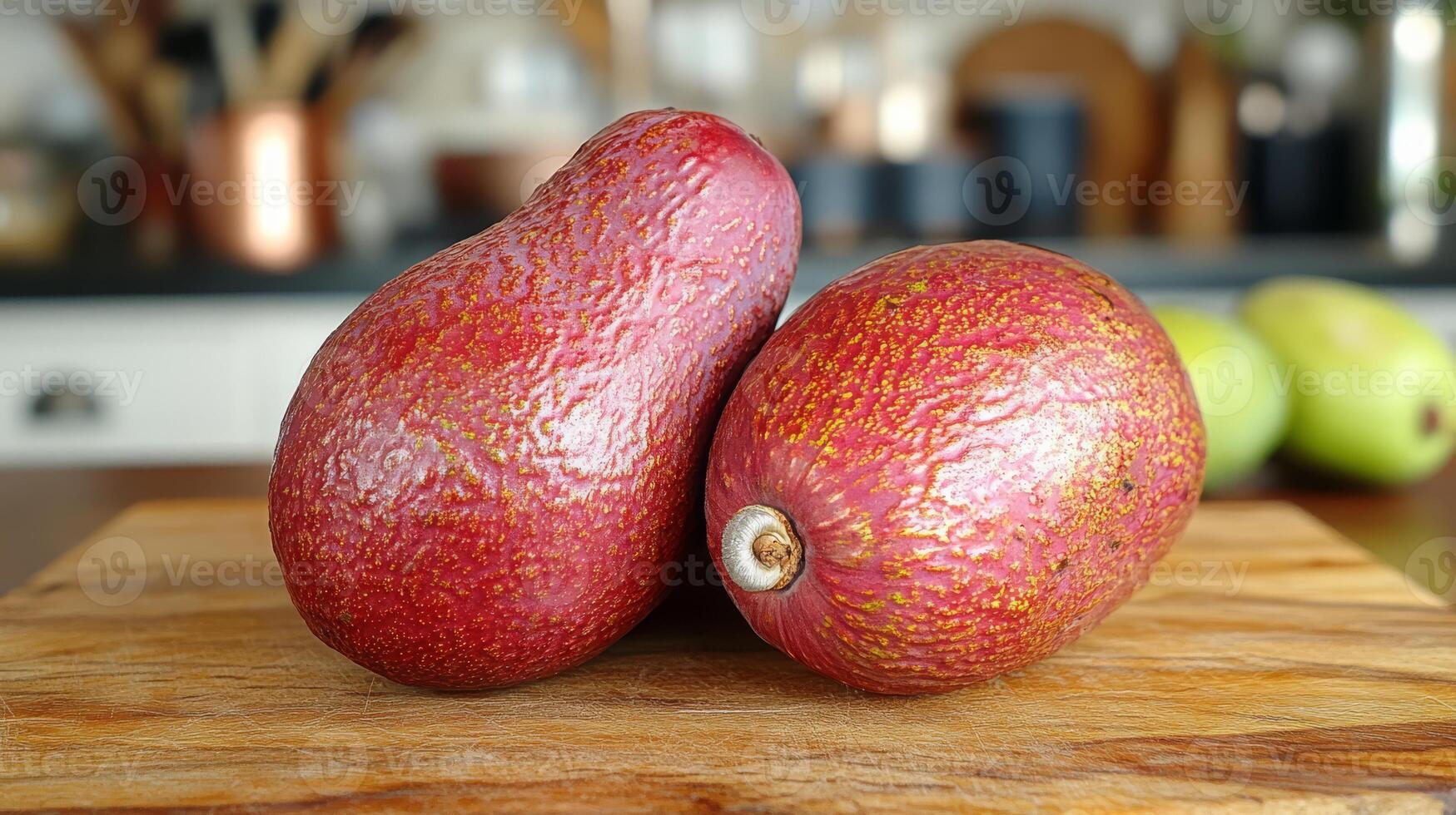 Bright red avocados rest on a wooden cutting board that highlights their unique color and texture, set against a stylish kitchen backdrop. photo