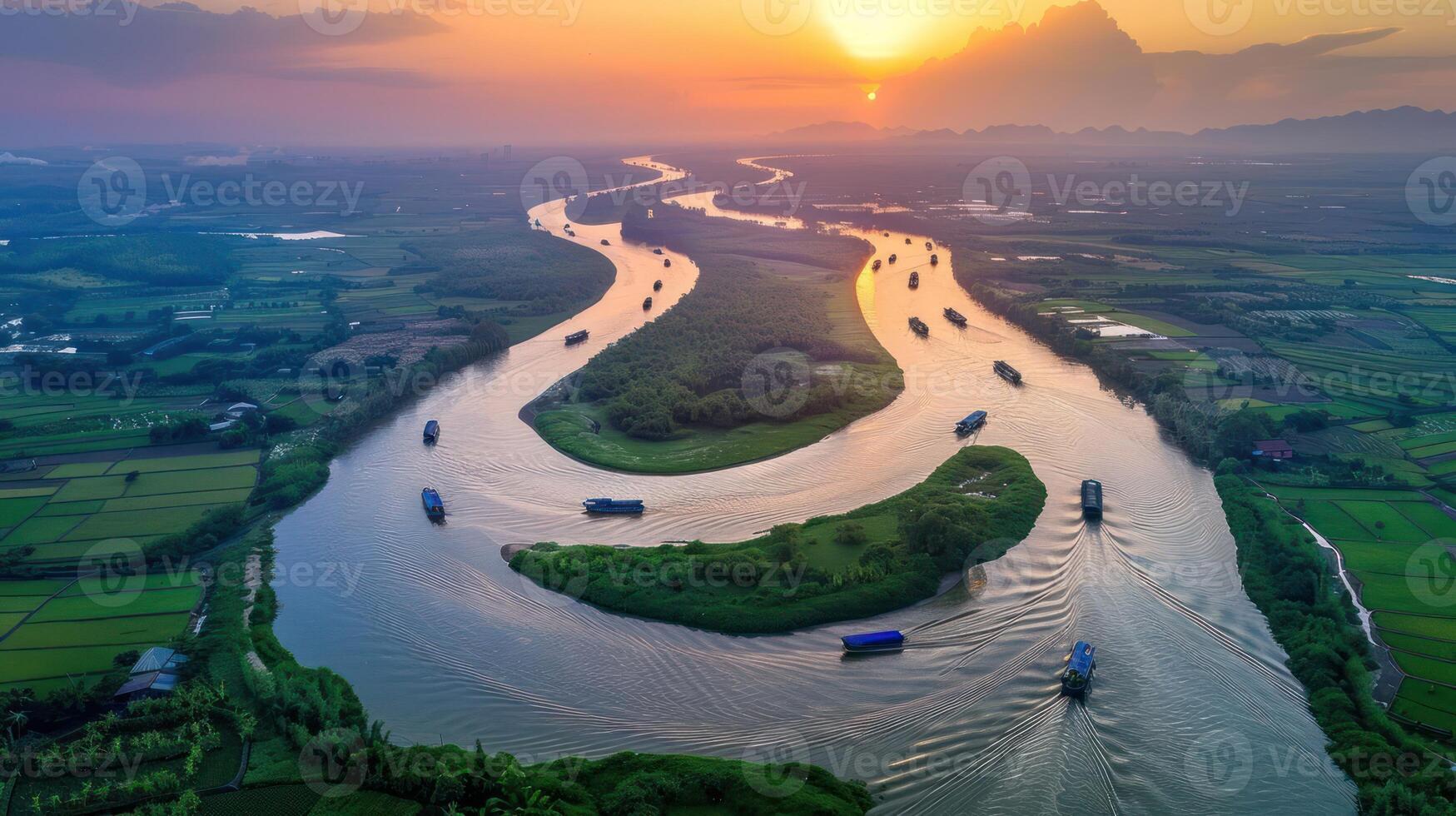 Aerial view of a winding river at sunset, surrounded by lush greenery and fields. photo
