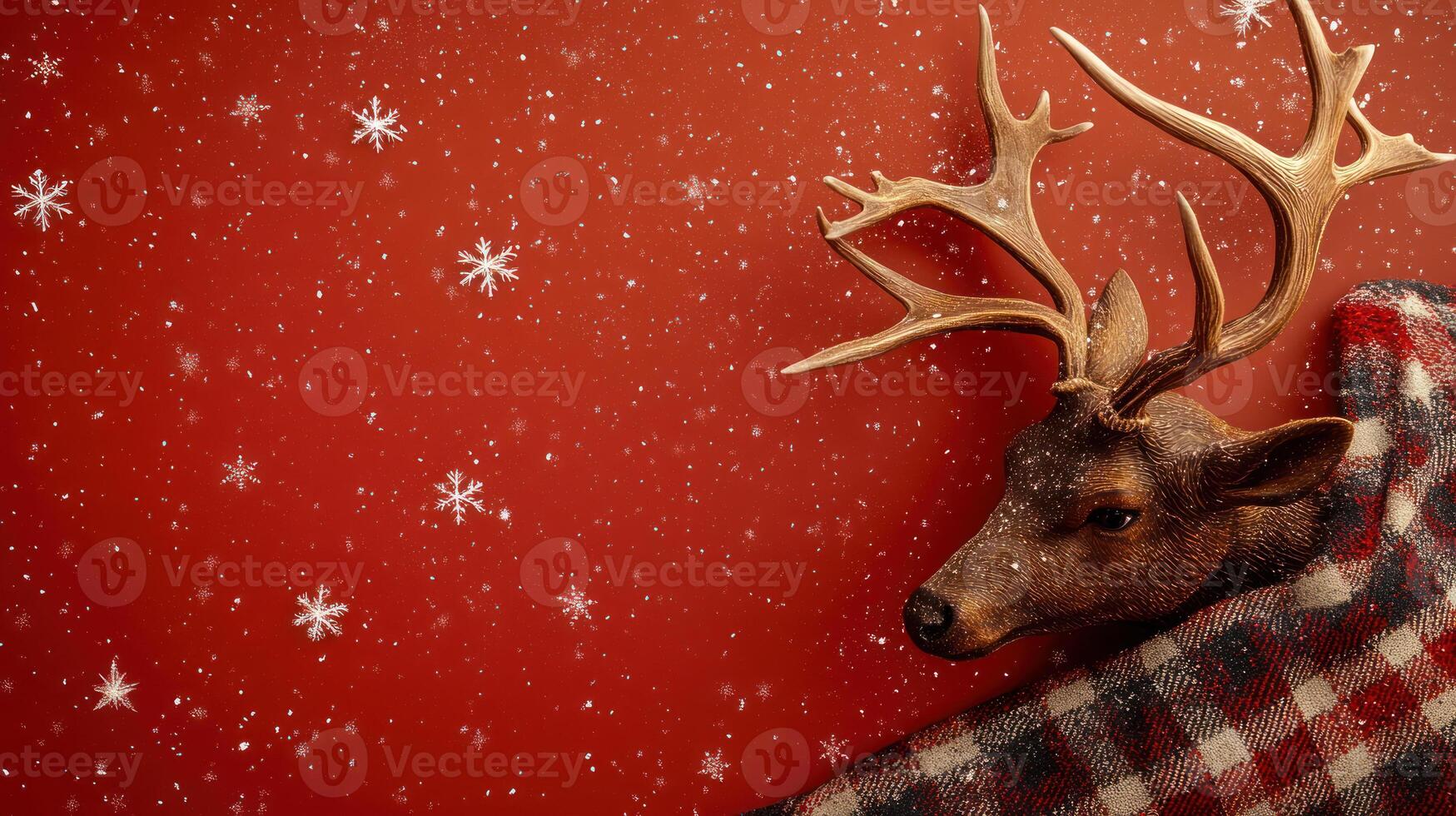 Cozy Reindeer with Antlers Wrapped in a Plaid Blanket Against a Red Background with Scattered Snowflakes, Perfect for Winter-Themed Holiday Designs and Decorations photo
