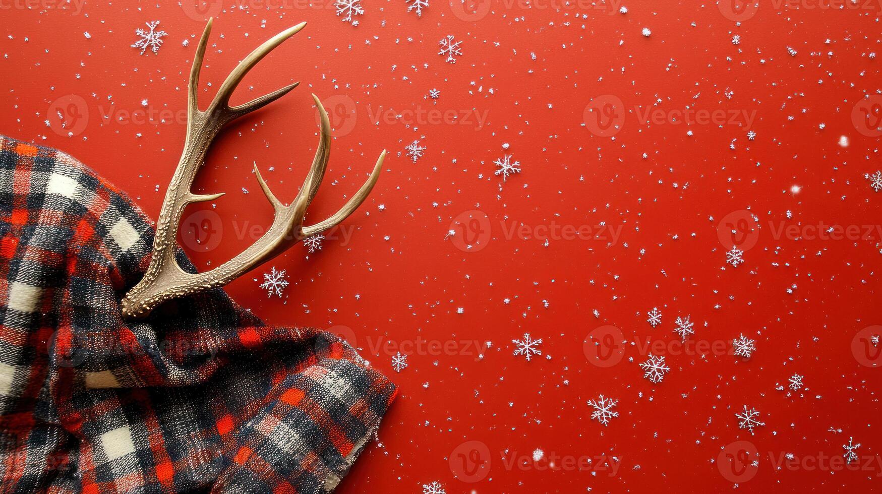 Cozy Winter Scene with Reindeer Antlers Resting on a Plaid Blanket Against a Vibrant Red Background with Scattered Snowflakes for a Festive Holiday Feel photo