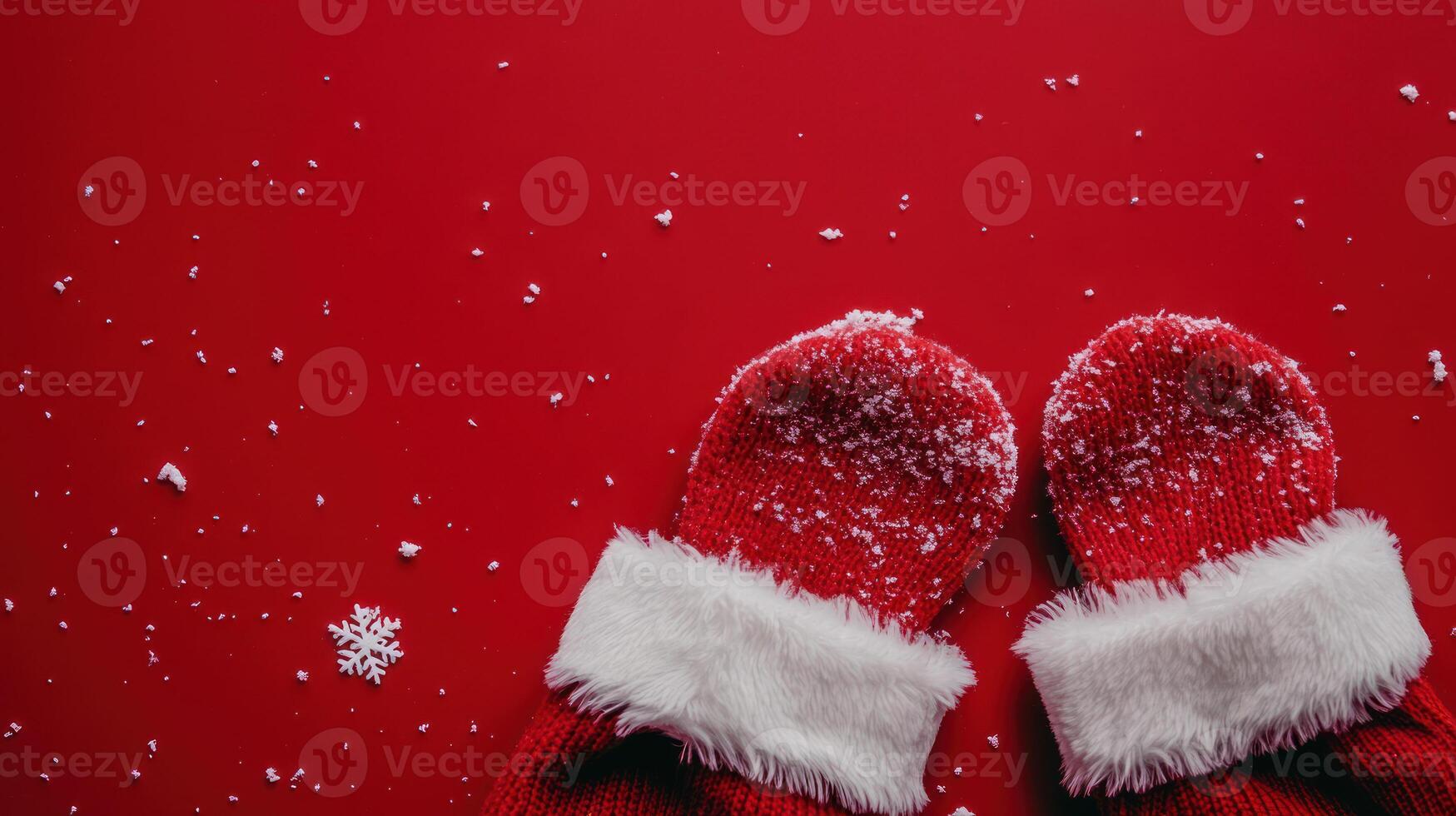 Festive Santa's Hat and Mittens on a Red Background with Snowflakes, Ideal for Holiday Themes and Seasonal Decorations with Space for Custom Text photo