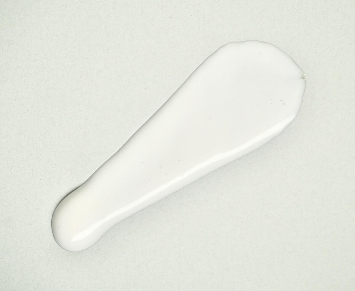 White lotion cream swatch texture isolated on horizontal white background. photo