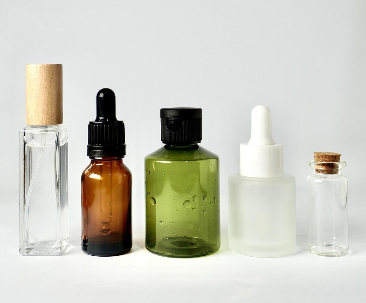 Group of spray and pipette skin care or health care product packaging bottle container isolated on horizontal white background. photo
