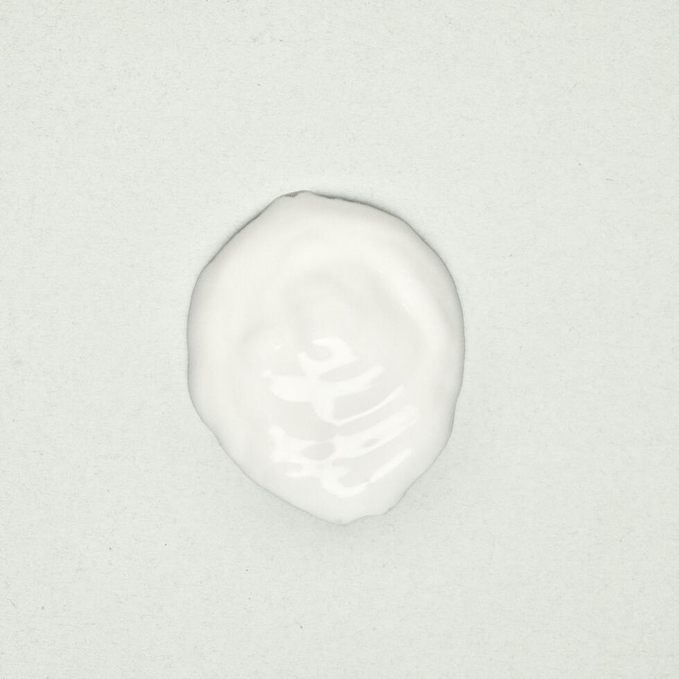 White lotion cream drop texture isolated on square white background. photo