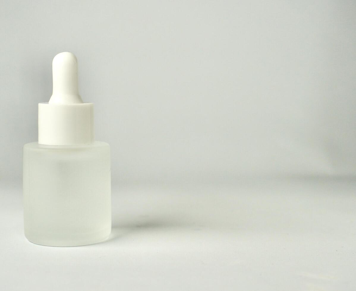 Matte semi transparent skin care pipette bottle container object isolated on horizontal copy spaced background. photo