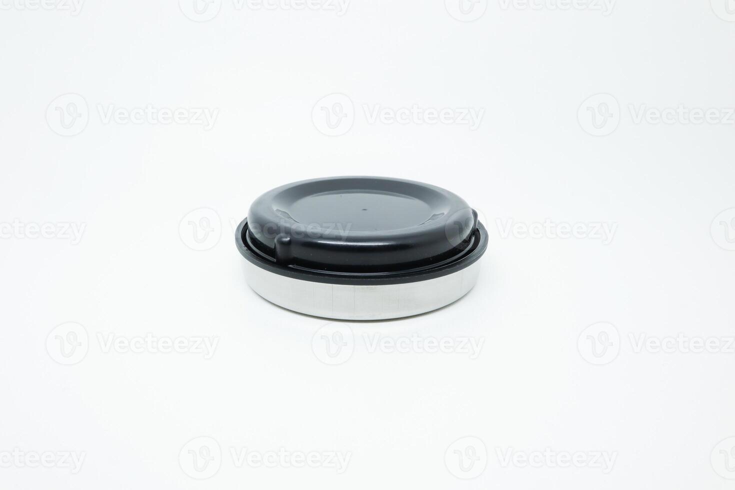 A small black and white container with a lid photo