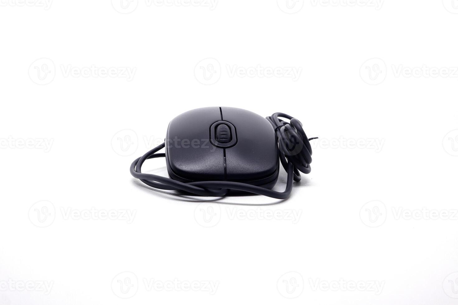 A black computer mouse on a white surface photo