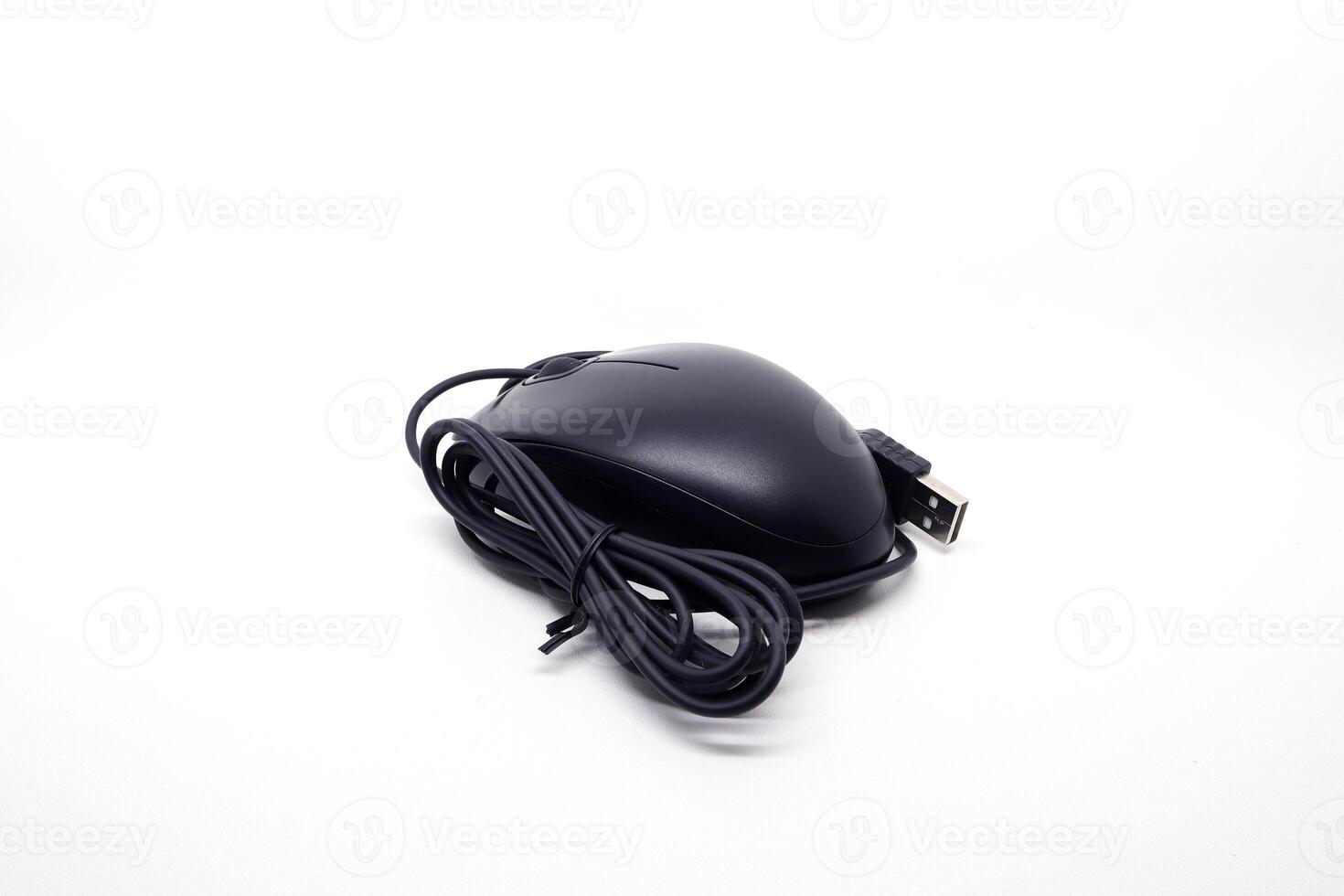 A black mouse with a cord on a white surface photo