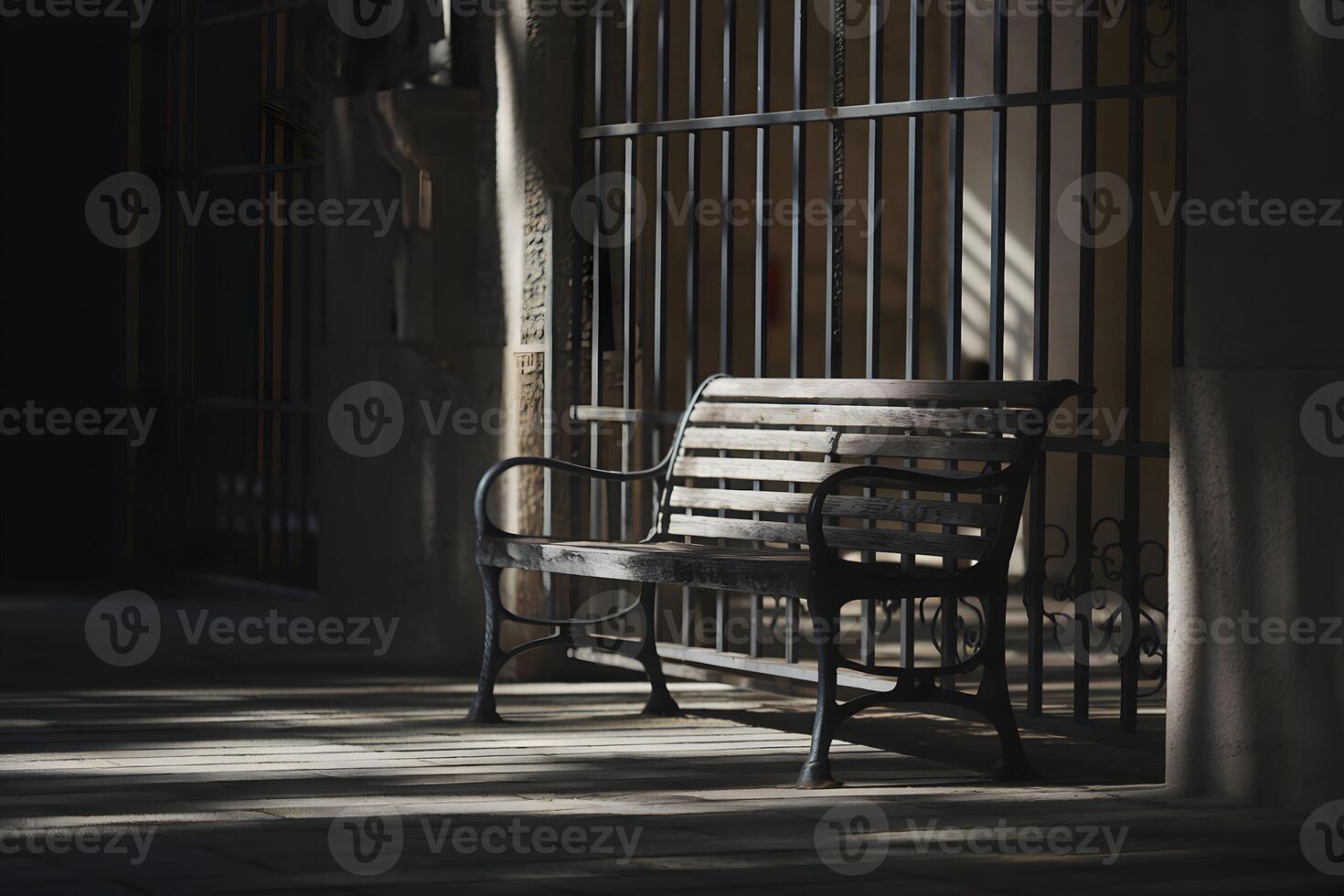 Weathered bench facing dimly lit bars, casting contemplative, serene shadows photo