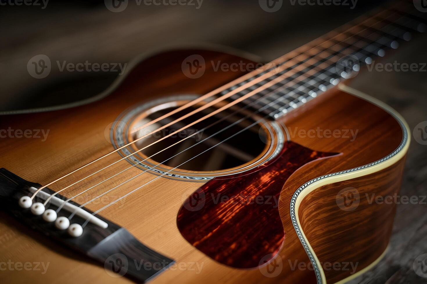 Acoustic guitar close up, rich wood and metallic strings highlighted by soft light photo