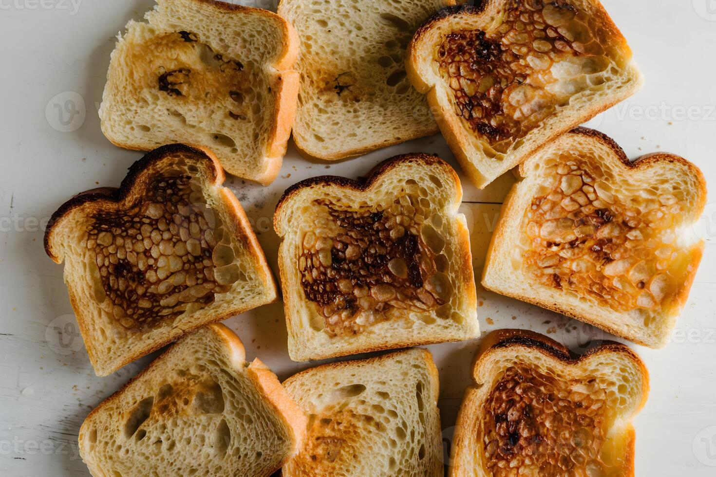 Slices of toasted bread arranged casually, golden brown with slight charred spots photo