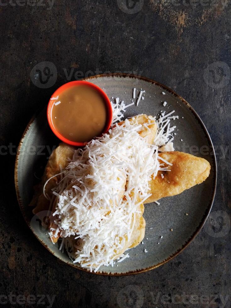 Banana fried and cheese on top photo