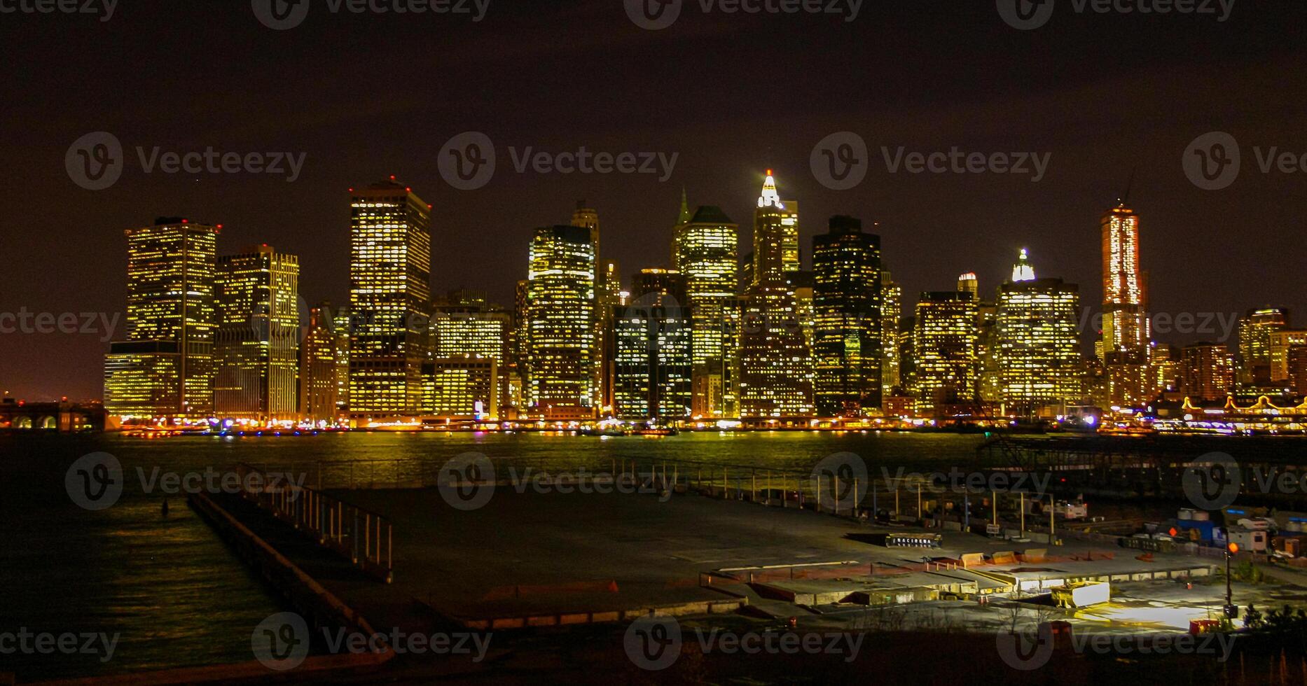View of the night Manhattan, the lights of skyscrapers glowing at night against the black sky, USA photo