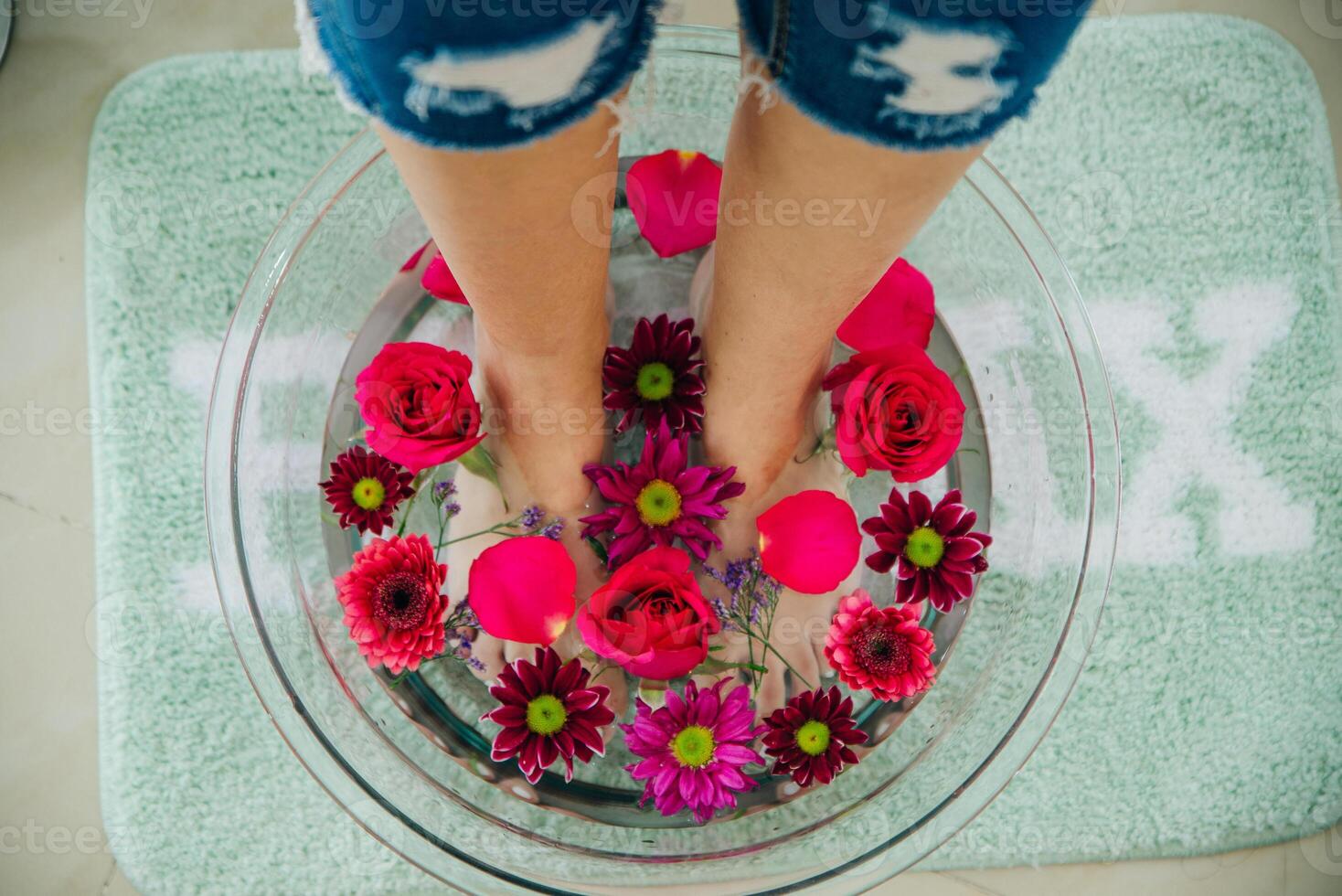 Foot bath in bowl with lime and tropical flowers, spa pedicure treatment, top view photo
