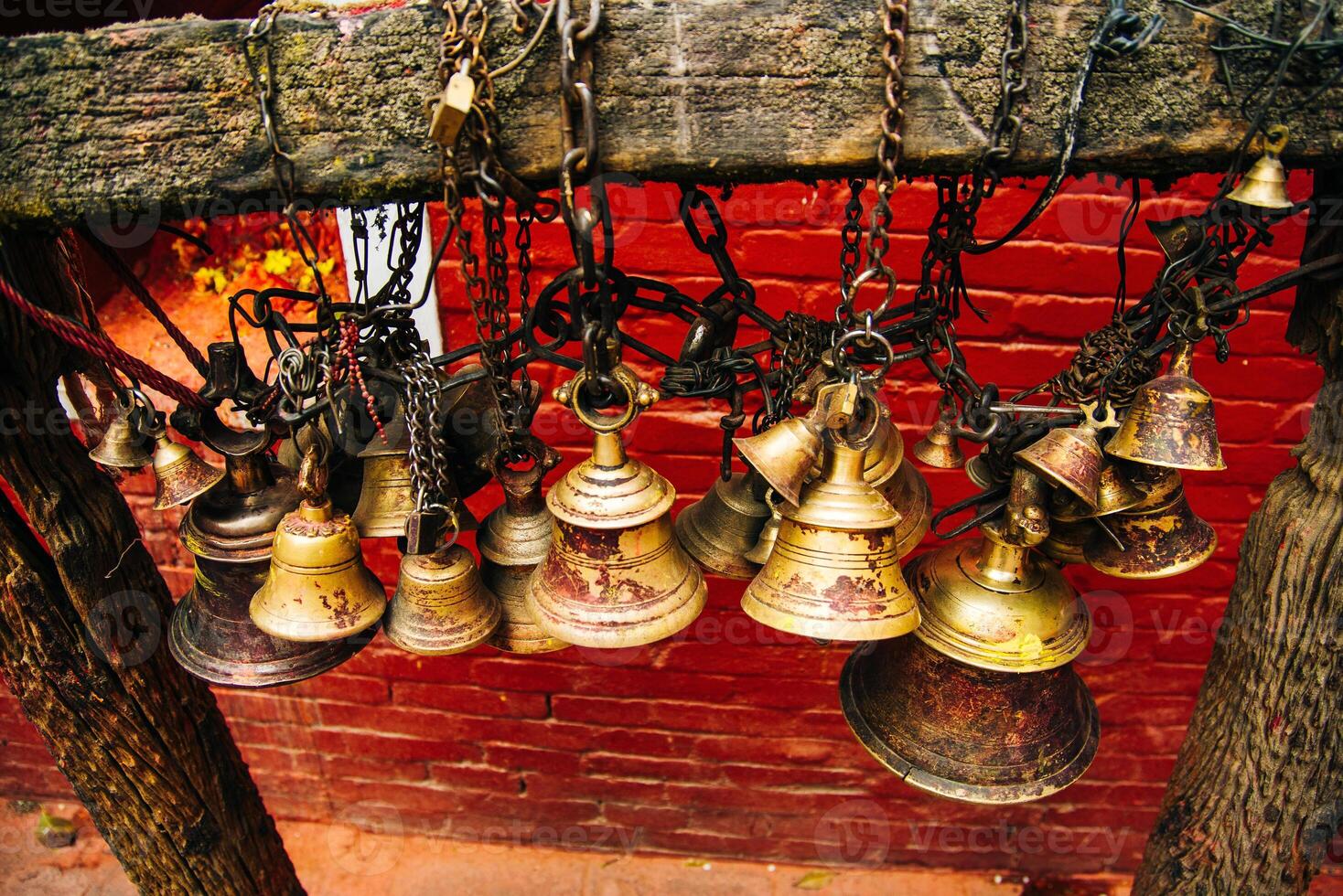 Many golden buddhist bells with wishes in sunlight photo