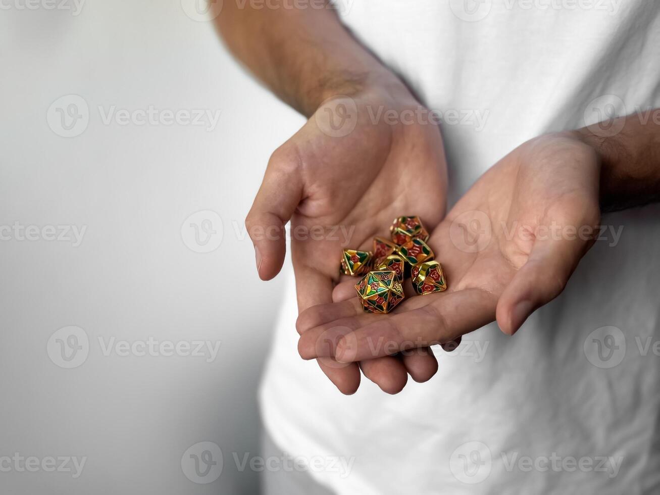 Person holding colorful polyhedral dice for role-playing games photo