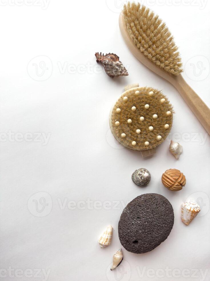 Spa essentials on white background with natural brushes and seashells photo