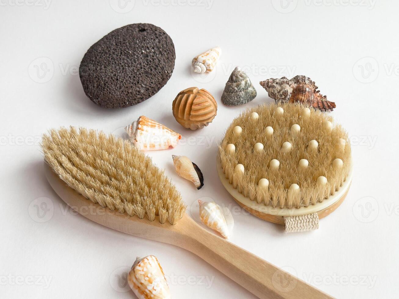 Coastal spa essentials. Natural brushes, pumice stone, and seashells on white background photo