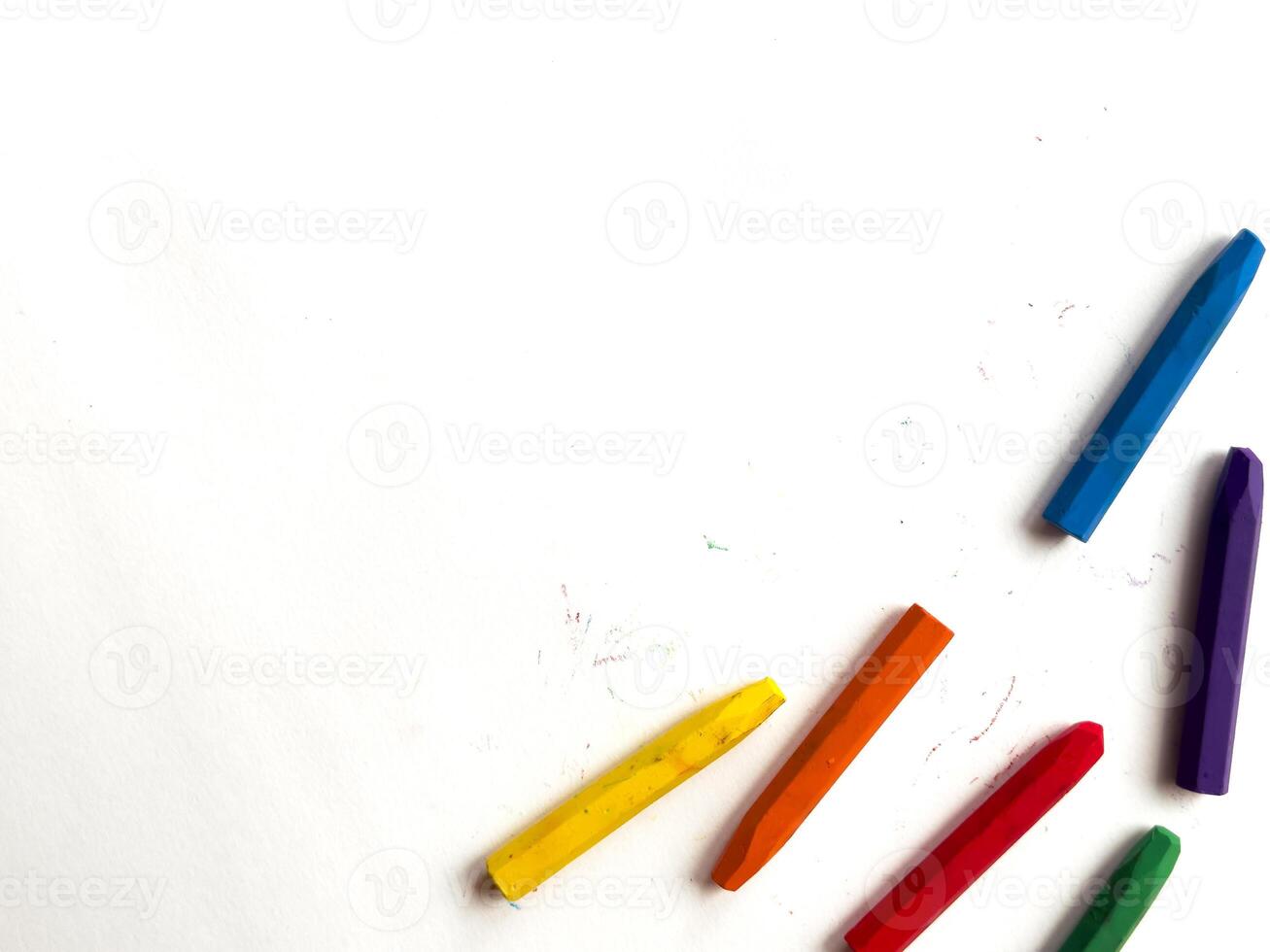 Colorful crayons arranged on white background for creative art projects photo
