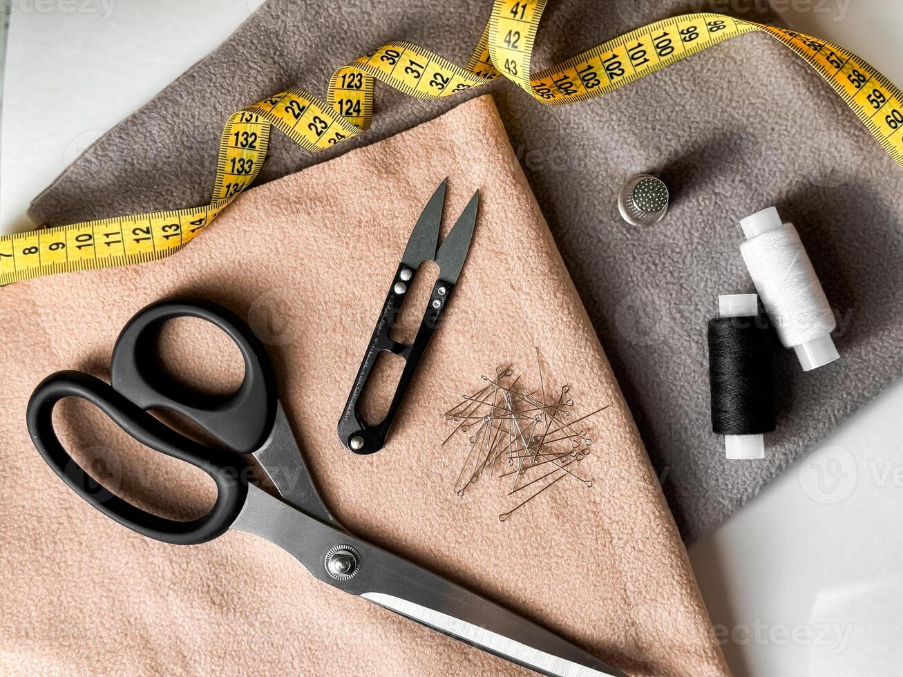 Sewing essentials. Tailoring tools with fabric, scissors, and measuring tape for creative projects photo