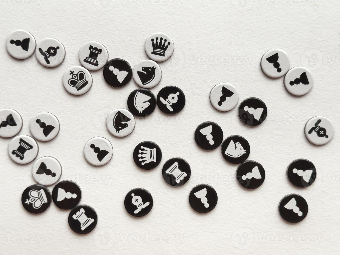 Minimalist chess piece buttons scattered on white background photo