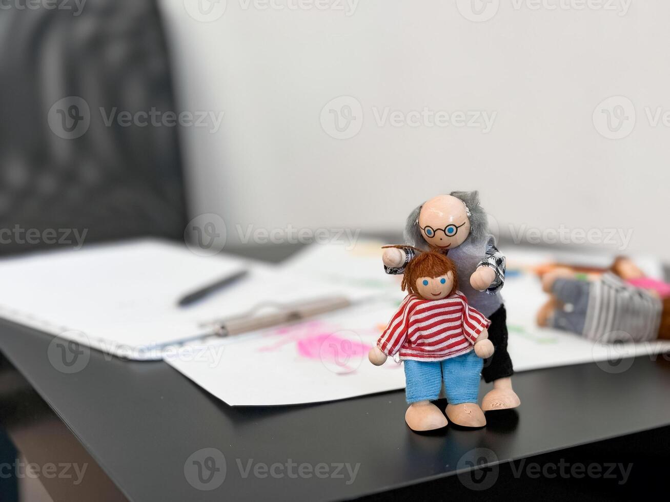 Colorful artistic dolls with sketches on desk background photo