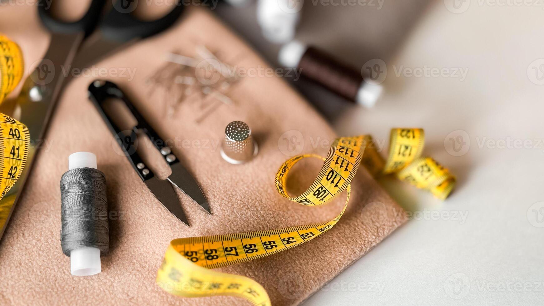 Sewing tools and materials on fabric with tape measure and scissors photo