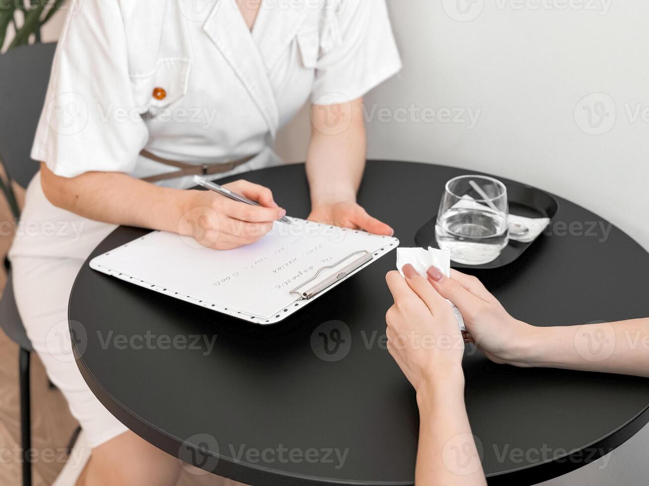 Therapist consulting a client in a modern office setting photo