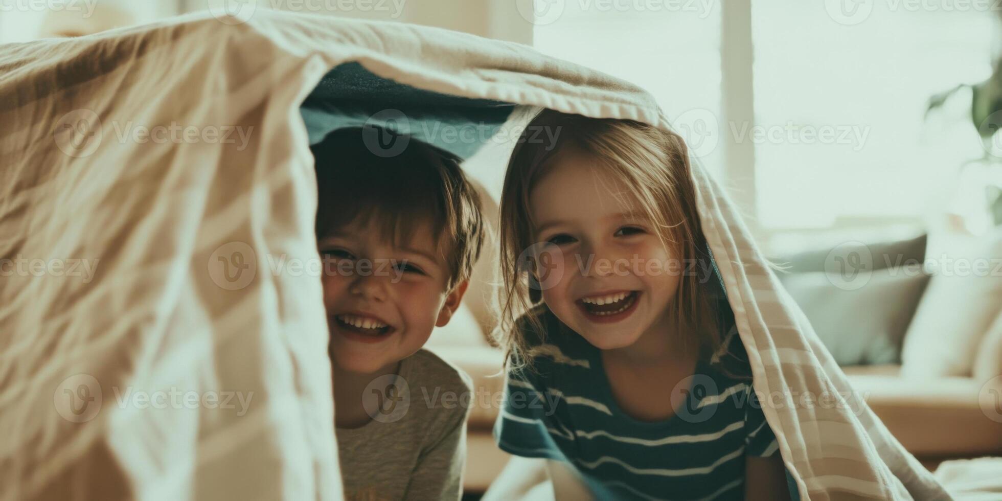 Joyful and Happy Children Engaging in Play and Fun Inside a Blanket Fort at Home photo