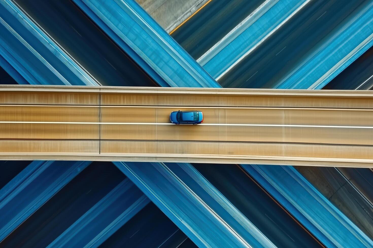 A sleek car glides over an intricate highway network captured from above, showcasing design and motion photo